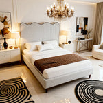 Luxurious bedroom with a large bed, chandelier, and decorative elements.
