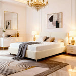 Modern bedroom with a white bed, chandelier, and abstract art on the wall.