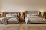 A deep-buttoned Chesterfield upholstered bed and a winged wingback upholstered bed shown side by side in a warm neutral bedroom.
