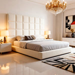 Modern bedroom with a large bed, decorative headboard, and chandelier.