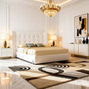 Modern bedroom with a large bed, decorative rug, and stylish lighting.