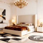Luxurious bedroom with a large bed, chandelier, and decorative elements.