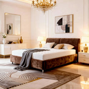Modern bedroom with a brown bed, chandelier, and abstract art.
