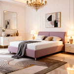 Modern bedroom with a pink bed, chandelier, and abstract art.