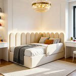 Beige upholstered bed with decorative pillows in a well-lit bedroom.
