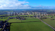 Aerial view of a rural yorkshire landscape with fields and buildings, featuring the brand 'Belsogno Beds'.