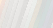 Close-up of pleated fabric with a soft gradient background