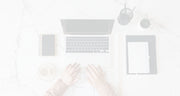 Laptop on a white surface with minimal objects