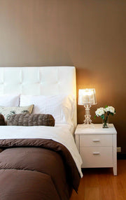 Bedroom with a bed, nightstand, and lamp.